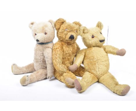 Three plush teddy bears Comprising a gold plush Merrythought bear with glass eyes and articulated limbs, height 48cm, a gold 