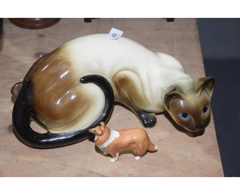 A ceramic figure of a Burmese catThe cat modeled in pouncing position, length 36cm, together with a Beswick figure of a colli