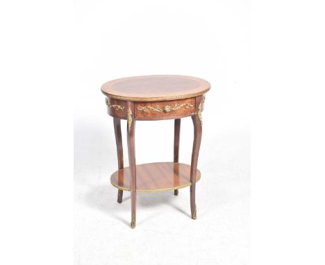 A Louis XVI style occasional table, mid 20th CenturyThe oval cross banded top with a gilt metal border above a frieze adorned