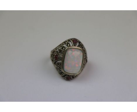 Silver ring with large central opal panel surrounded by rubies and Marcasite's 