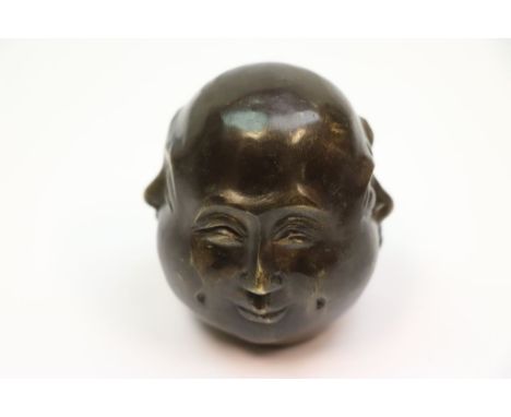 A four faced Buddha paperweight signed to base 