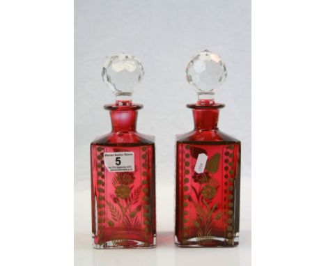 Pair of vintage cut Cranberry Glass Decanters with clear Glass stoppers &amp; applied Gilt detailing to the Floral decoration