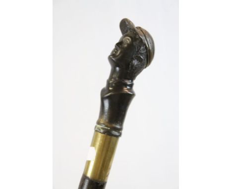 Brass &amp; Ebonized Wooden walking stick with Metal Jockey Knopp, approx 97cm long and unscrews into three parts