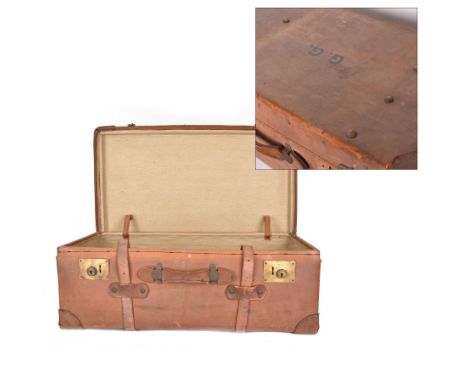 Early 20th century leather trunk, with brass fixtures, leather straps and buckle fastenings, embossed to the top with initial