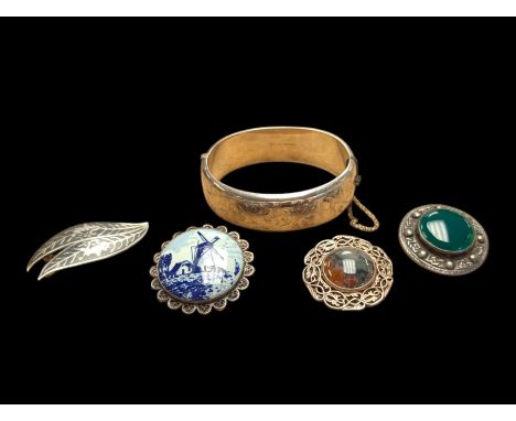 Silver bangle with four silver broochesCondition Report:Approx 28 grams