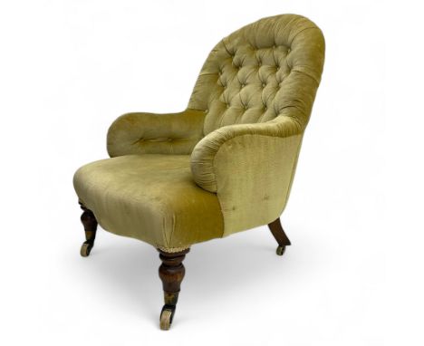 Late 19th century button-back nursing chair, upholstered in olive-green velvet, shaped back with padded arms, raised on turne
