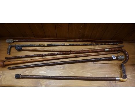 Seven Assorted Walking Sticks, circa early 20th century, to include a military type stick, (7)