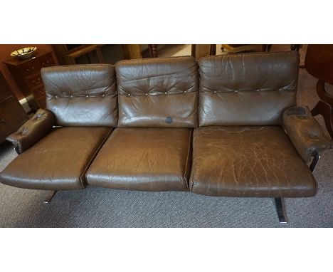 A Retro Brown Three Seater Leather Sofa, Raised on chrome supports, 70cm high, 180cm wide