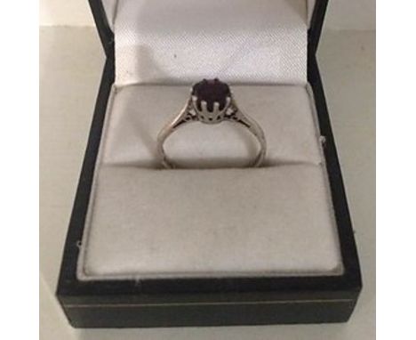 A Ladies Silver Dress Ring, Set with a single ruby coloured stone, ring size N1/2