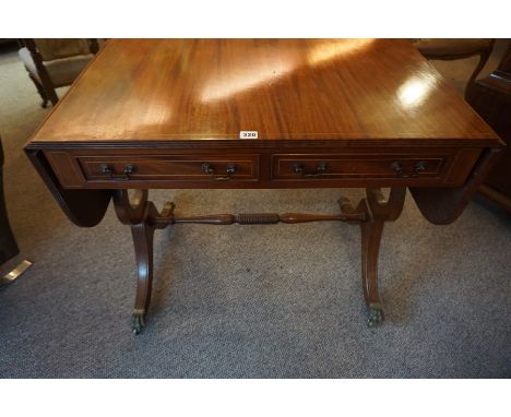 A Mahogany Sofa Table, With two drawers, raised on gilt animal paw sabots and brass castors, 74cm high, 142cm wide, 54cm deep