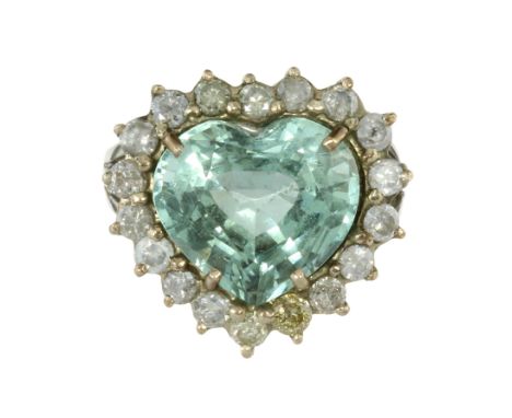 AN AQUAMARINE AND DIAMOND CLUSTER RING in 18ct white gold set with a large, heart shaped modified brilliant cut aquamarine of