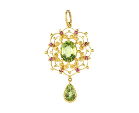 AN ANTIQUE PERIDOT AND RUBY PENDANT in 15ct yellow gold set with a central oval cut peridot surrounded by gold wirework spira