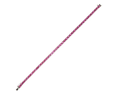 A RUBY LINE BRACELET in 18ct white gold comprising a single row of oval cut rubies totalling 7.35 carats. Stamped 750, length