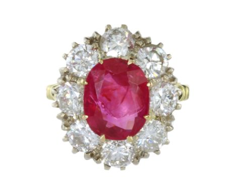 A 4.44 CARAT BURMA NO HEAT RUBY AND DIAMOND RING in yellow gold set with an oval cut ruby of 4.44 carats surrounded by eight 