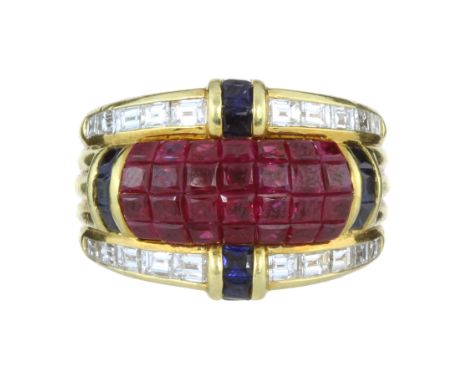 A RUBY, SAPPHIRE AND DIAMOND COCKTAIL RING, DENOIR CIRCA 1980 in 18ct yellow gold with a central panel of calibre cut rubies,