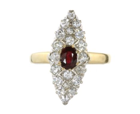 AN ANTIQUE RUBY AND DIAMOND DRESS RING in 18ct yellow gold set with a central oval cut ruby of 0.60 carats surrounded by old 