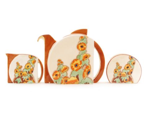 Clarice Cliff - Sunshine - A Stamford teapot, milk and sugar circa 1931 transfer printed and painted with hollyhocks in orang