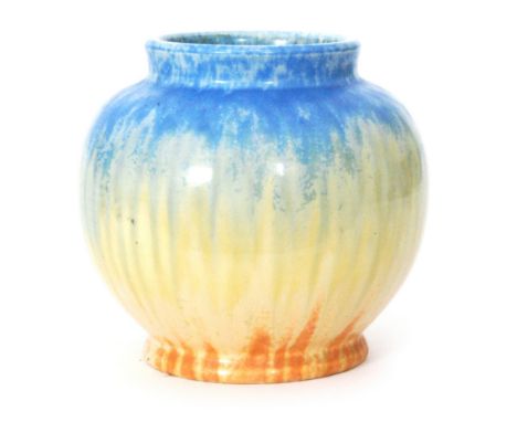 Ruskin Pottery - A crystalline glaze vase of footed ovoid form decorated in a streaked blue to yellow to orange, impressed ma