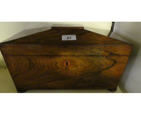 A large 19th Century rosewood sarcophagus formed tea caddy with turned side handles and three section interior.