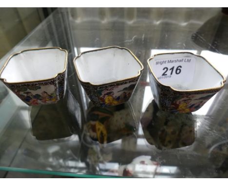 A set of three small 20th Century Oriental enamel bowls or sake cups, decorated with panels of various figures. CONDITION REP