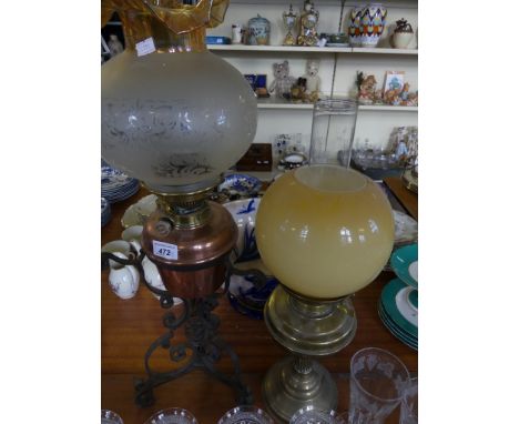 An early 20th Century brass based oil lamp together with a further oil lamp with copper font mounted on a turned iron stand (
