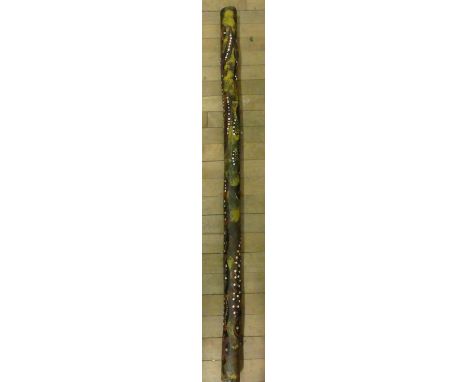 A modern hardwood didgeridoo with decoration of various animals.