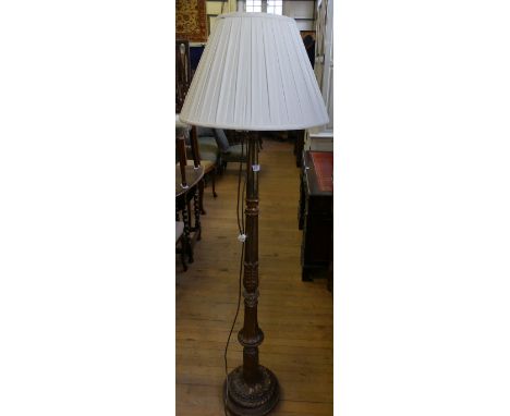 A modern gilt wood standard lamp with foliate carved detail