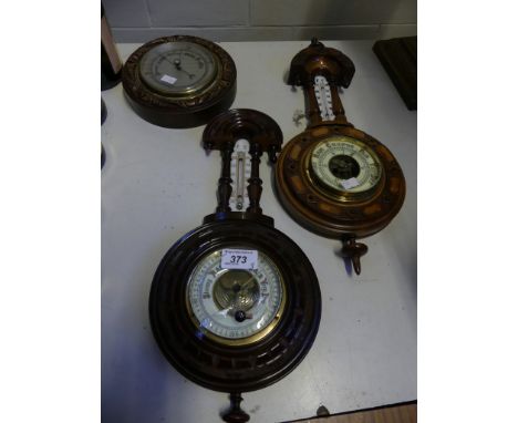 Two late 19th/early 20th Century aneroid barometer/thermometer combinations in carved wooden banjo shaped frames, together wi