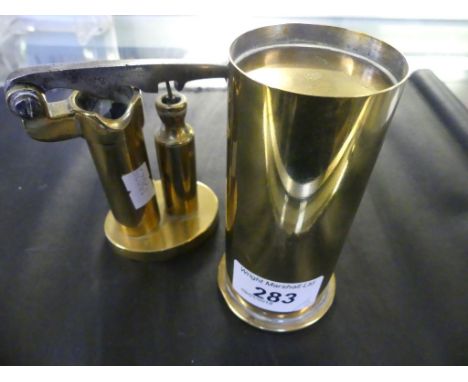 A mixed lot comprising a small brass travelling paraffin cooker, together with a further vintage brass cartridge loading tool