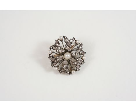 A VICTORIAN DIAMOND AND PEARL BROOCH PENDANT of flowerhead form, set with graduated rose-cut diamonds and seven untested pear