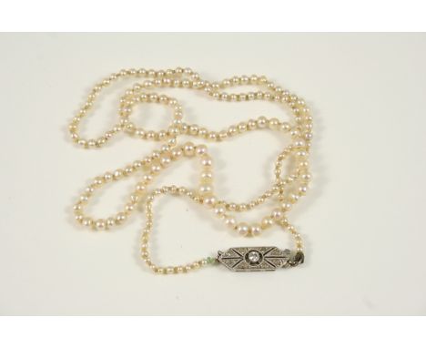 A SINGLE ROW GRADUATED NATURAL PEARL NECKLACE the one hundred and ninety two pearls graduate to a diamond set clasp, 49cm. lo