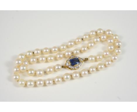 A SINGLE ROW UNIFORM CULTURED PEARL NECKLACE the pearls measure approximately 6.5mm., and are set to a gold clasp centred wit