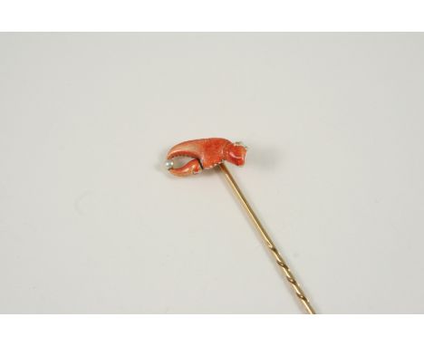 A LOBSTER CLAW STICK PIN the gold pin is mounted with a lobster claw holding a small pearl.