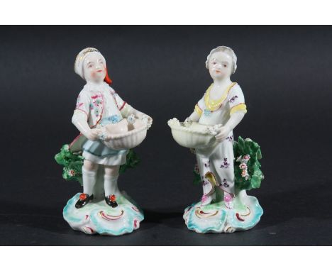 PAIR OF DERBY FIGURAL SALTS, later 18th century, patch marks, the couple holding small baskets before bocage, height 11.5cm (