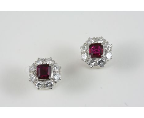 A PAIR OF RUBY AND DIAMOND CLUSTER EARRINGS each set with a square-shaped ruby within a surround of eight brilliant-cut diamo