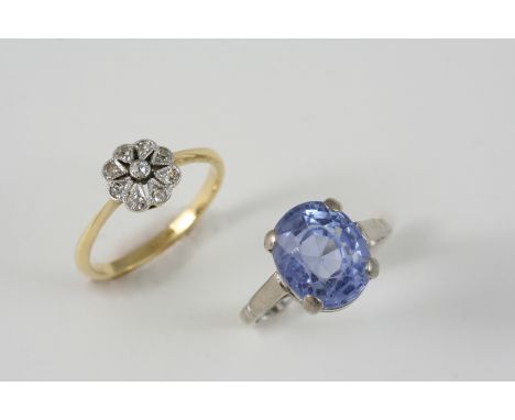 A DIAMOND CLUSTER RING set with circular-cut diamonds in 18ct. white gold, size N, together with a sapphire single stone ring