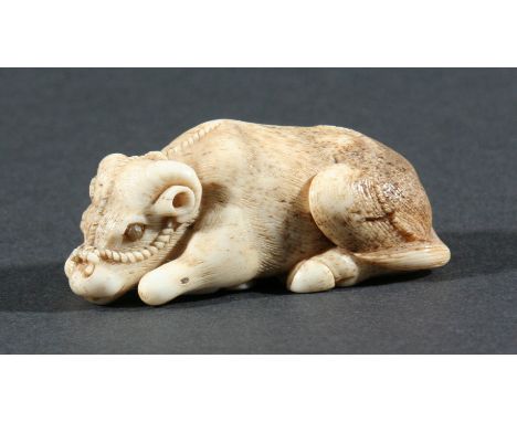 THREE JAPANESE NETSUKE, the first modelled as a recumbent cow, height 5.5cm, together with a mother and child playing, 4.2cm 