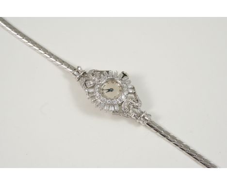 A LADY'S DIAMOND COCKTAIL WRISTWATCH the circular dial with Arabic numerals, with circular and baguette-cut diamonds set to t