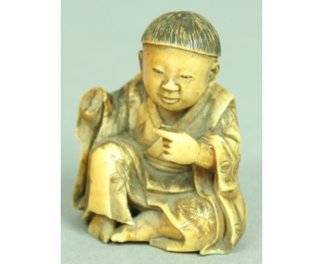 JAPANESE IVORY NETSUKE OF A BOY, lacking inset signature seal, height 4.5cm; together with another of a recumbent water buffa