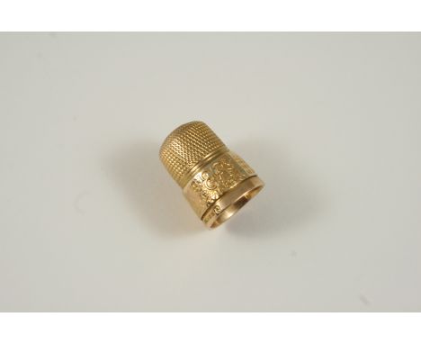 A 9CT. GOLD THIMBLE engraved E 11 R 1953,  for the Coronation of Elizabeth II, and with embossed decoration, 6.7 grams.