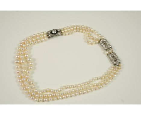 A THREE ROW GRADUATED CULTURED PEARL AND DIAMOND NECKLACE the pearls graduate from approximately 4.0mm. to 7.4mm., and are se