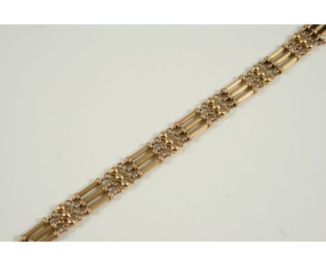 A 15CT. GOLD FANCY GATE LINK BRACELET with concealed clasp, damaged, 17.5cm. long, with extra links, 16.4 grams in total.
