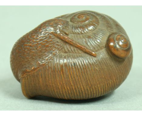 JAPANESE WOODEN NETSUKE OF A SNAIL, signed, 3.5cm; together with another of a frog and snail on a lily leaf, signed and a thi