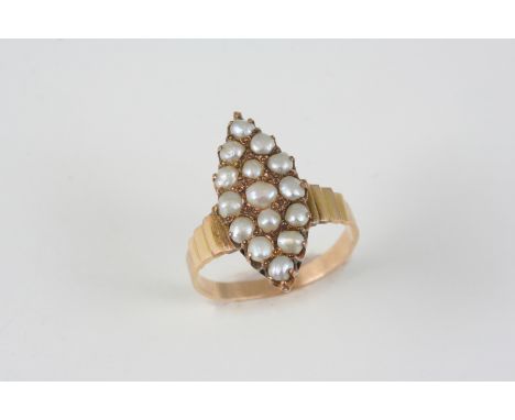 A GOLD AND PEARL RING the marquise-shaped gold ring is set with graduated pearls. Size O.