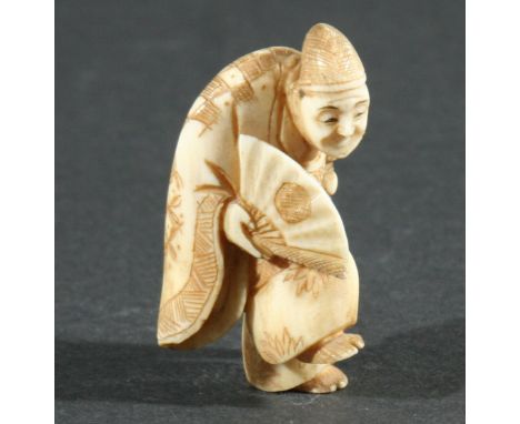 THREE JAPANESE NETSUKE, the first carved as a man standing on one foot holding a fan, height 4.5cm, together with a man eatin