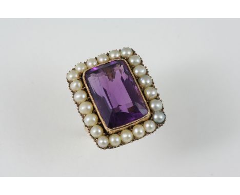 AN AMETHYST AND PEARL CLUSTER RING the large rectangular-shaped amethyst is set within a surround of half pearls, in gold. Si