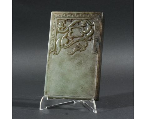 CHINESE MOTTLED GREEN JADE INK OR MIXING STONE, of rectangular form carved with a dragon scrolling around a shallow well insi