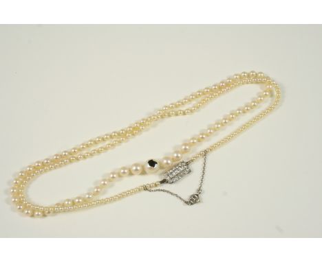 A SINGLE ROW GRADUATED NATURAL PEARL NECKLACE the pearls graduate to a rectangular-shaped diamond set clasp, 49.5cm. long. Ac