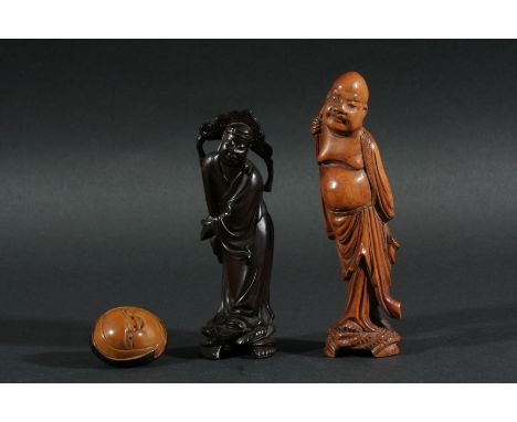 JAPANESE HARDWOOD NETSUKE, carved as a grimacing face, signed, 4cm; together with two hardwood okimono of Immortals and a sma