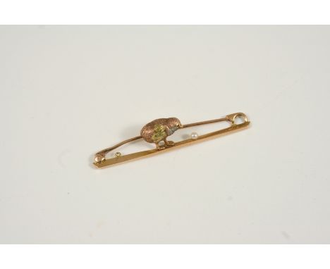 A 15CT. THREE COLOUR GOLD CHICK BROOCH realistically formed, with cabochon ruby eye, 5cm. long, 2.8 grams. With box.